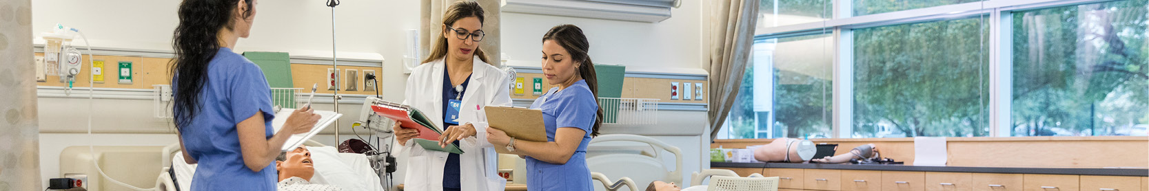 Two nurses and a doctor in a patient's room